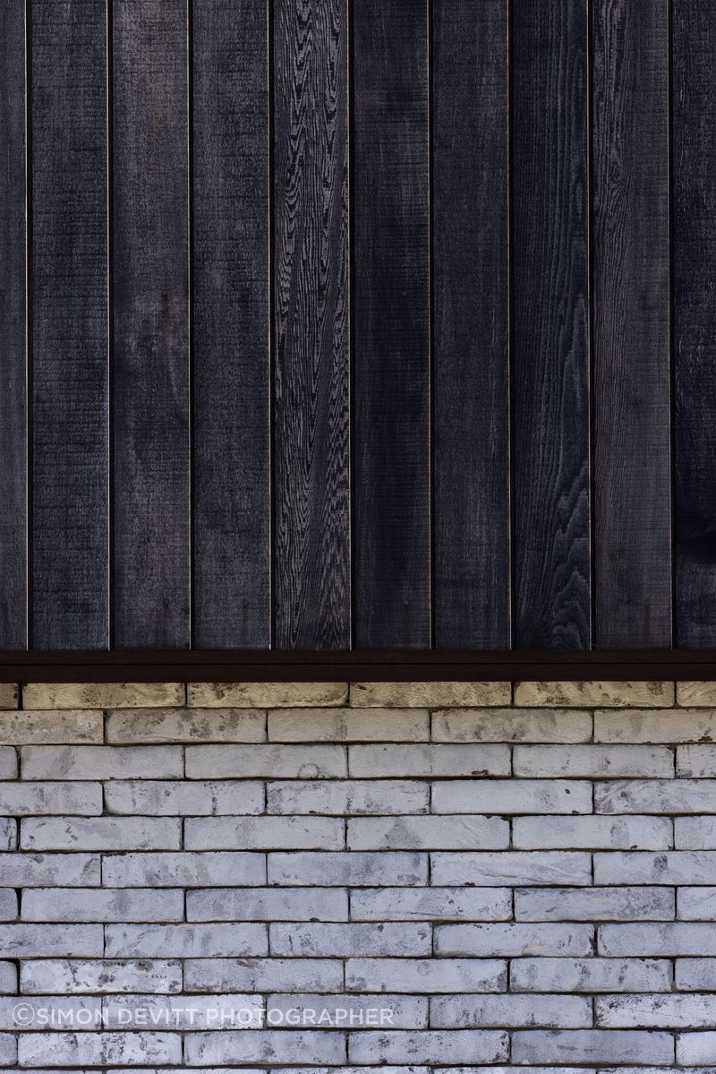 Contrasting textures and tones of Pitau's exterior