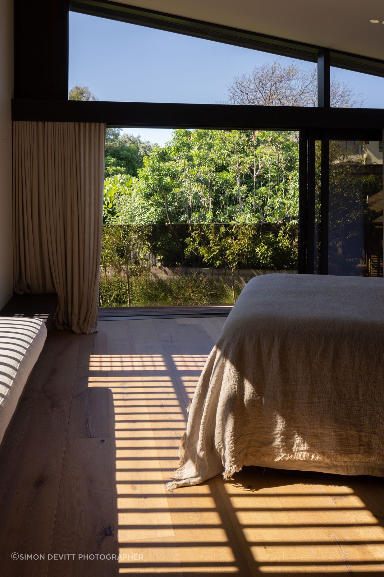 Natural linens work with timber in the 'Master Retreat'