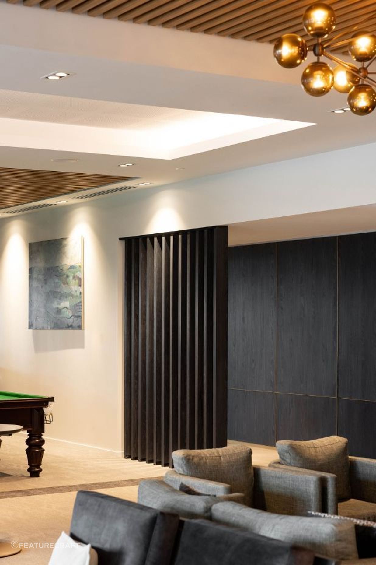 The MDF panels were finished with black pine veneer and elevated with a custom brass trim, evoking a sense of elegance