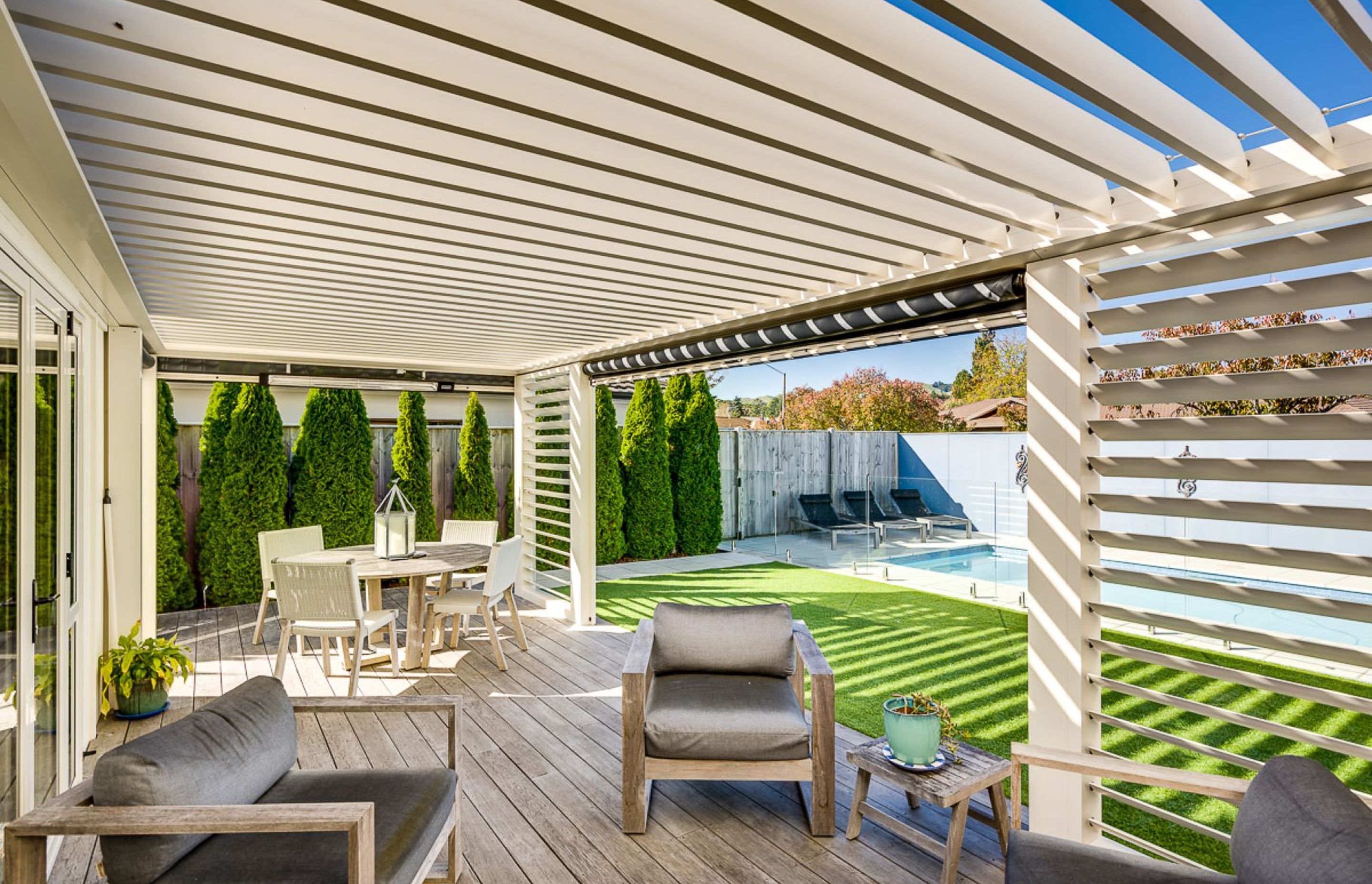 In this Hawke's Bay property, a louvre system uses vertical and horizontal louvres along with blinds to create a complete outdoor room.