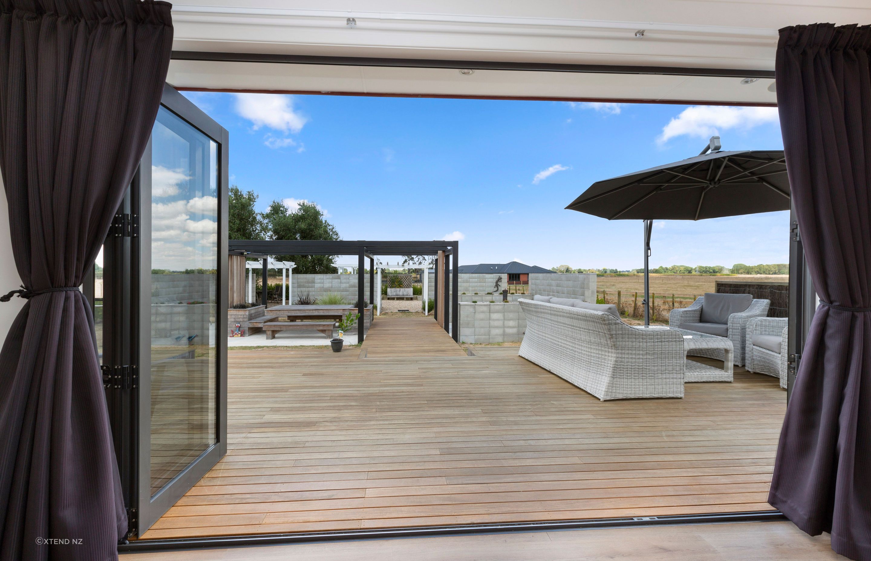 Bifold doors were installed, opening out onto a large Vitex deck for great indoor-outdoor flow.