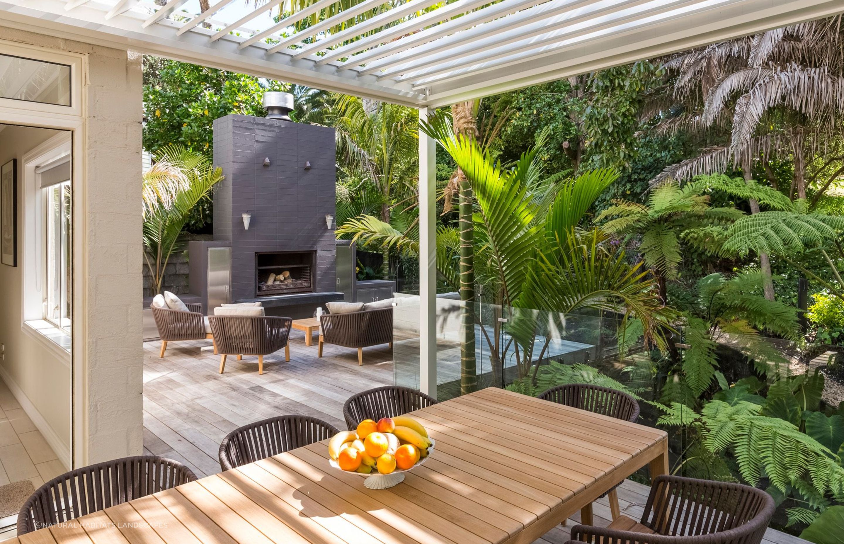 A well-designed outdoor living space, like this one in Remuera, allows you to get the most out of it, even in dense, lush settings like these.