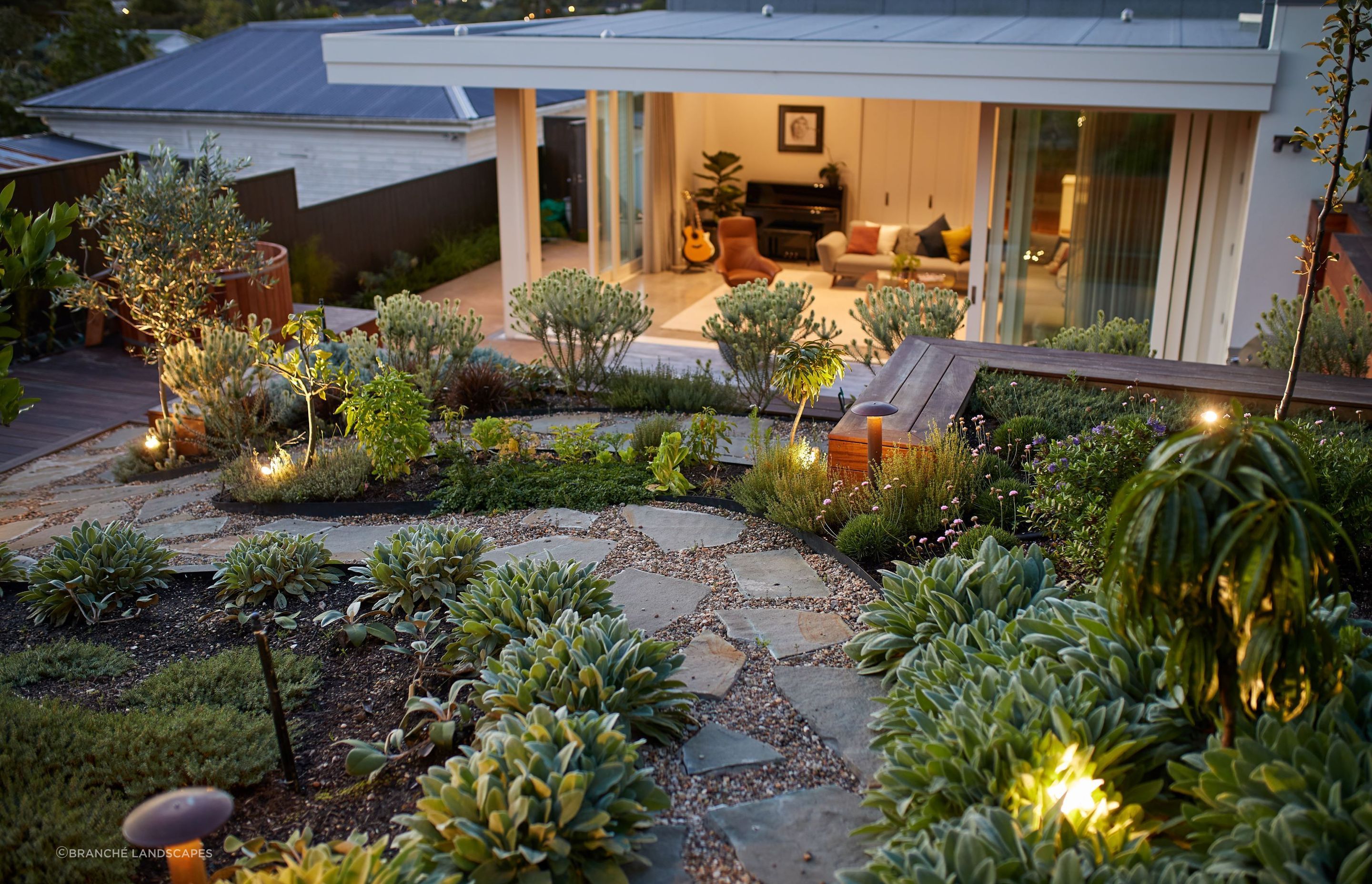 A holistic approach to hardscaping, complemented by a lush garden design like this in Kingsland, will elevate your outdoor space immeasurably.