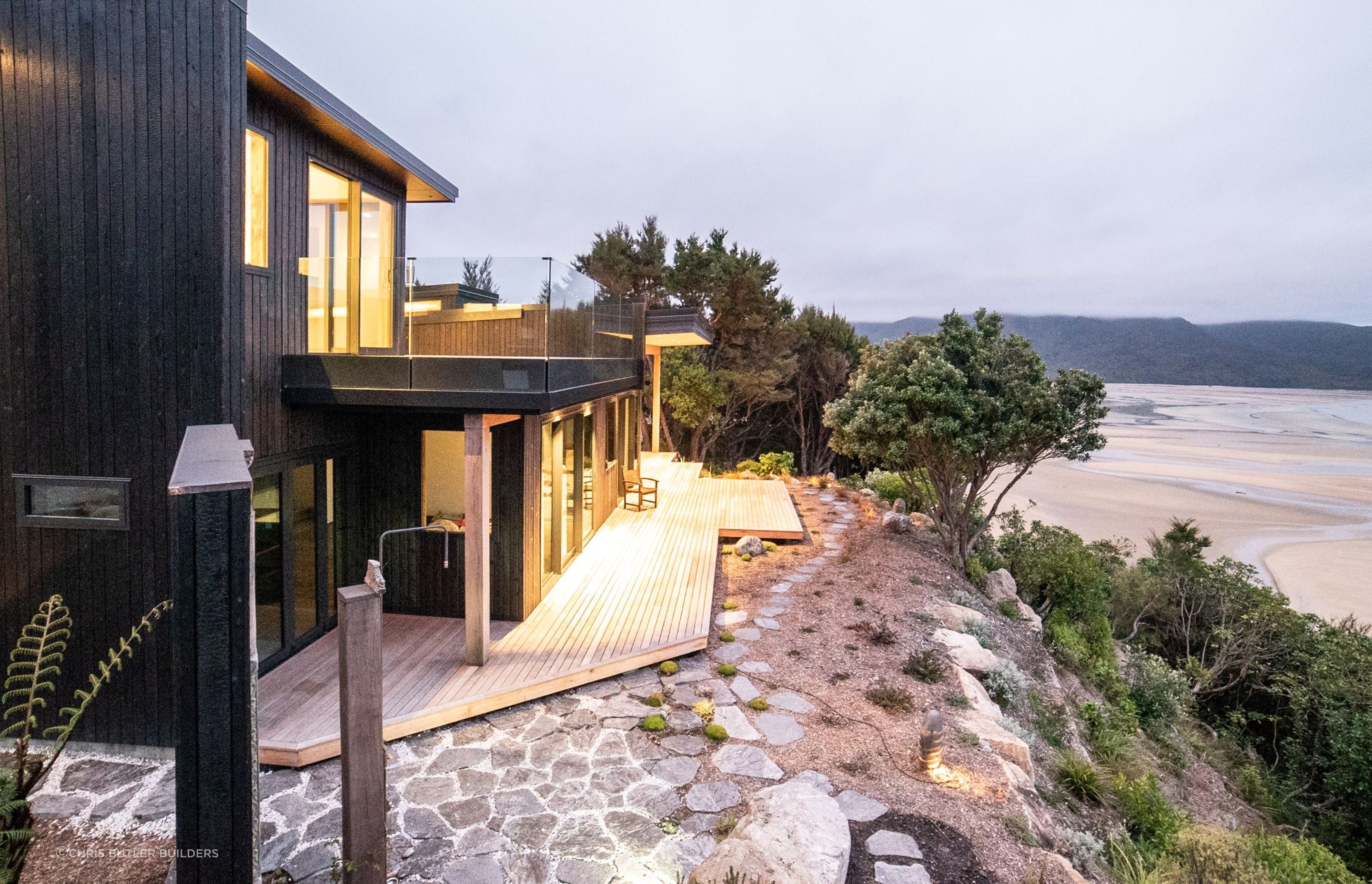 Stone, pebbles and timber — just some of the hardcaping material featured in this stunning coastal home.