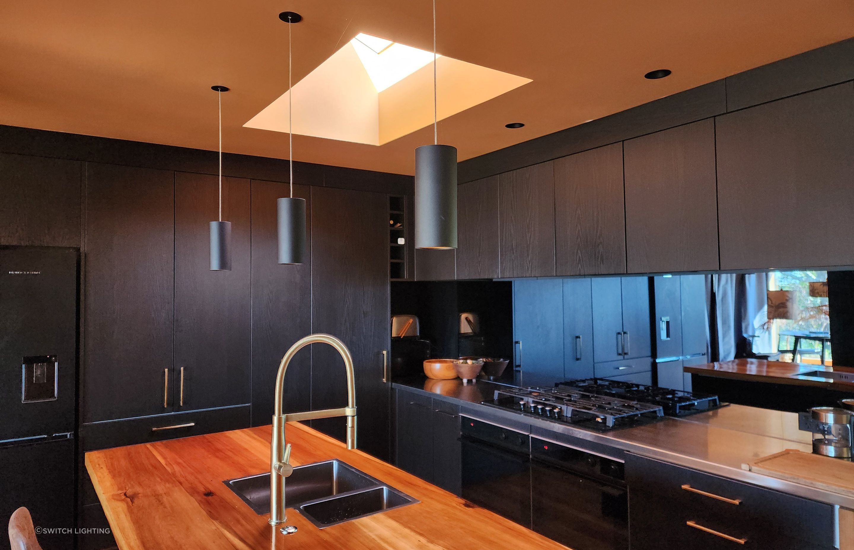 The Switch Lighting ZELA décor Pendant has been applied as task lighting over this kitchen island.