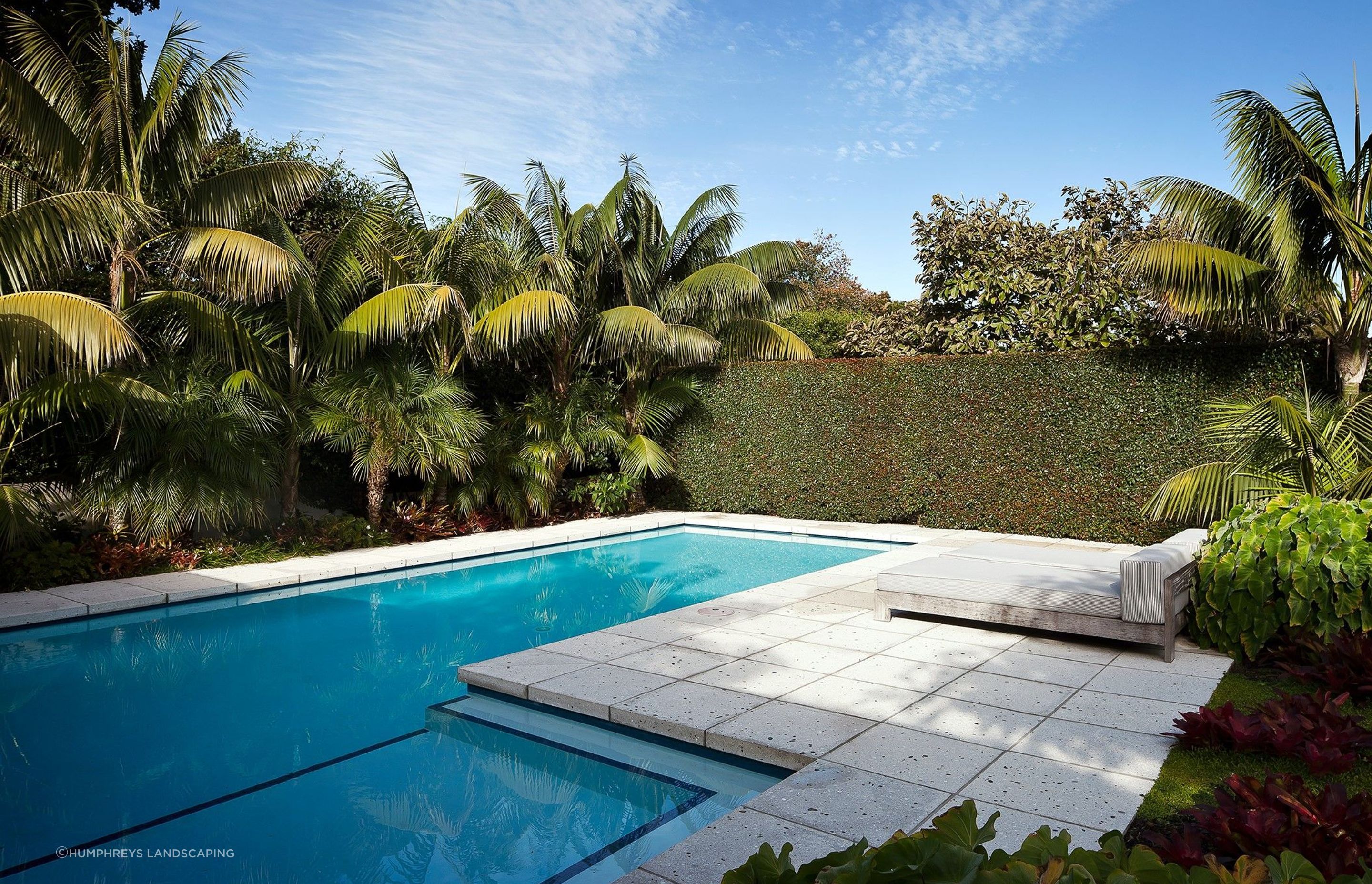 This private swimming pool in Herne Bay uses hedges as a natural form of screening for privacy and an accentuated feeling of seclusion.