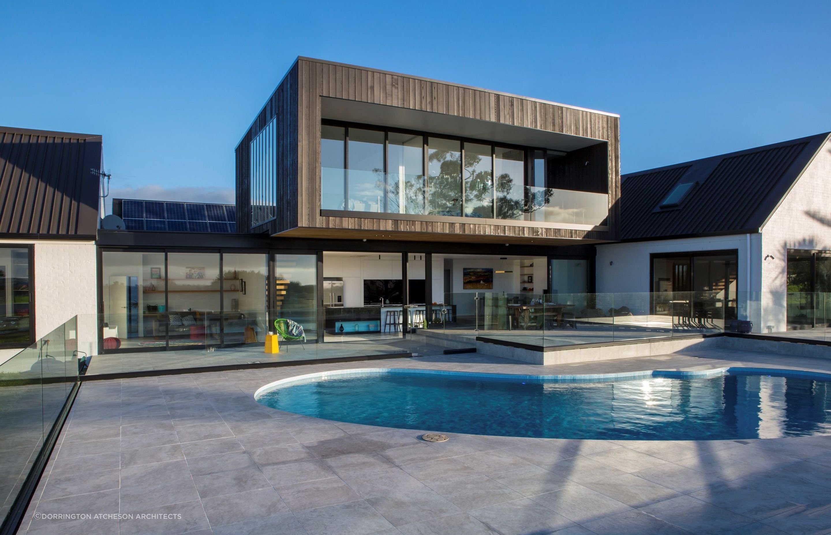 A modern take on a kidney-shaped pool in this stylish home in Whitford. | Photography: Emma-Jane Hetherington