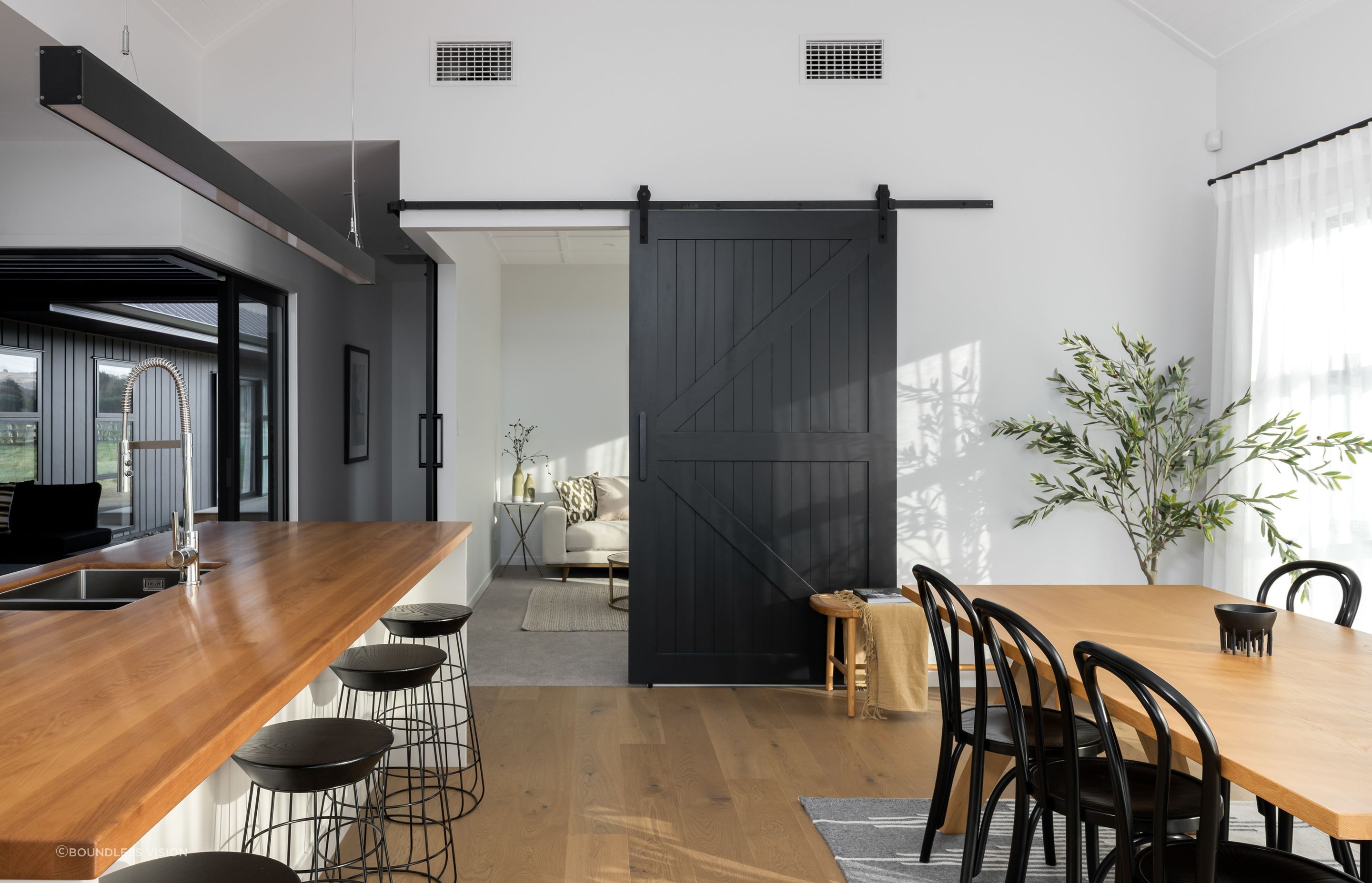 Cleverly placed barn-style doors separate or connect spaces on demand. 