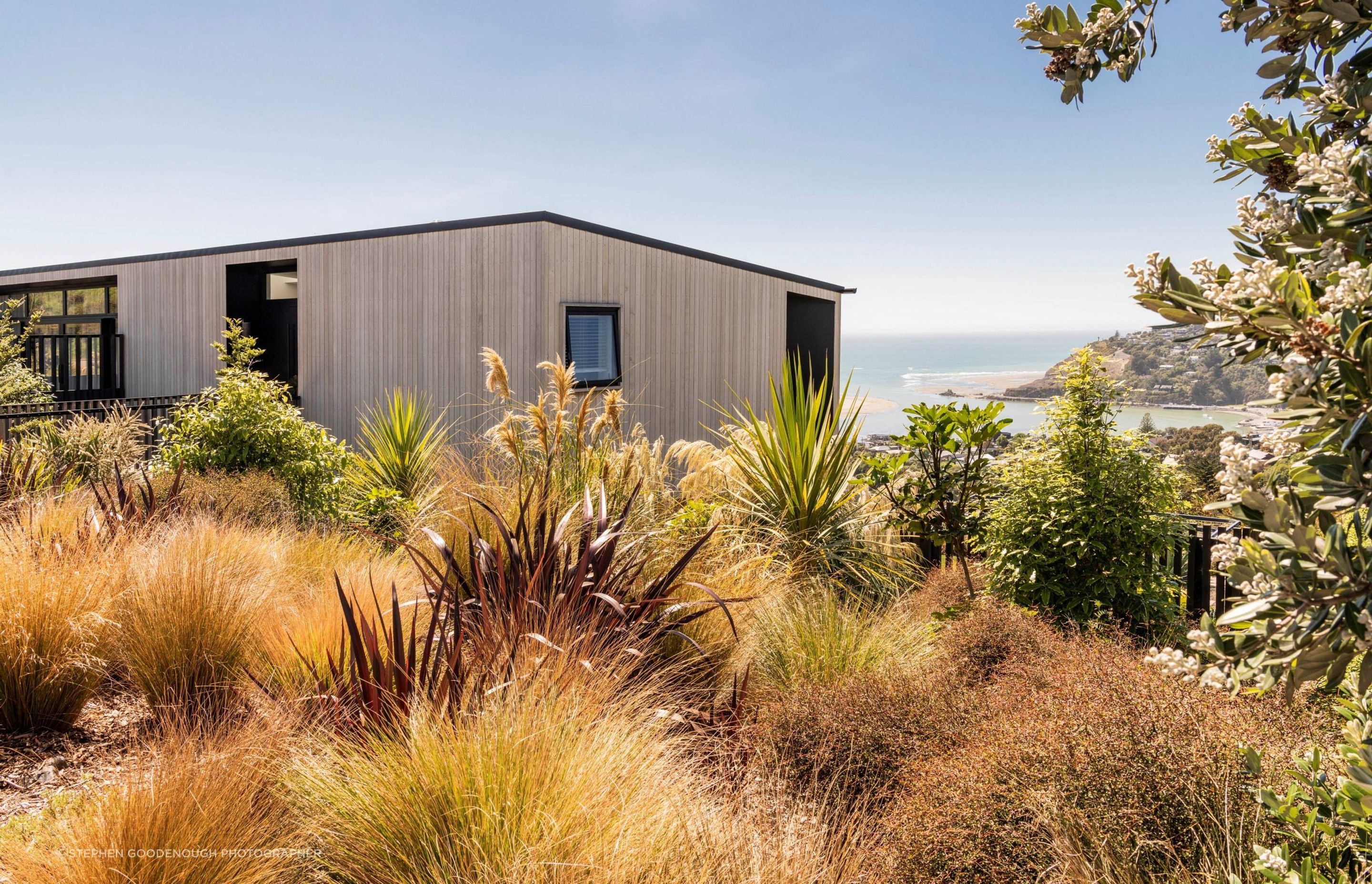 A wonderful example of naturalistic planting with some iconic natives in this hillside home in Christchurch. | Photography: Stephen Goodenough Photographer