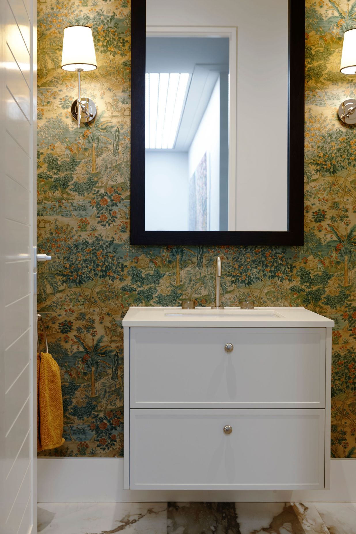 The powder room in this Remuera home features ornate wallpaper to create an elegant, stately feel.