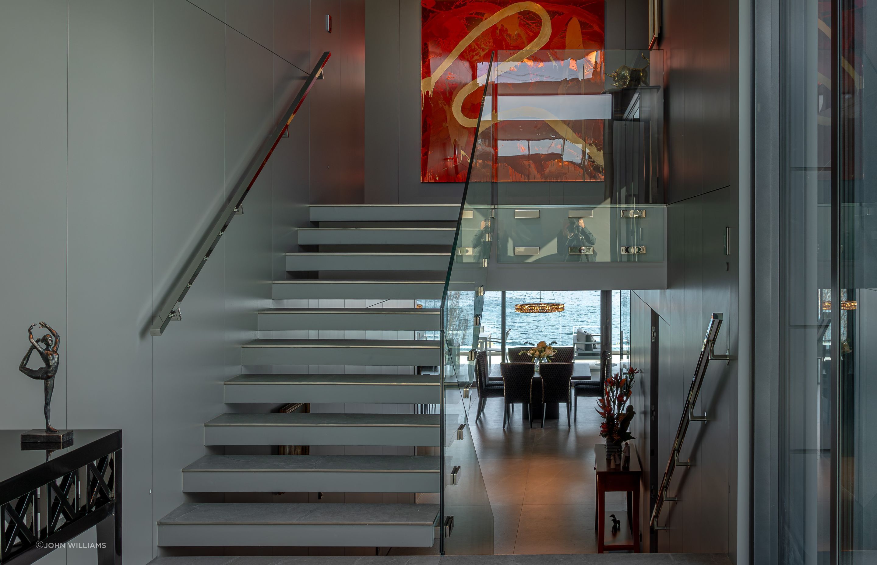 In the foyer, staircases seem to float, and bannisters glow, backlit by LED lights.