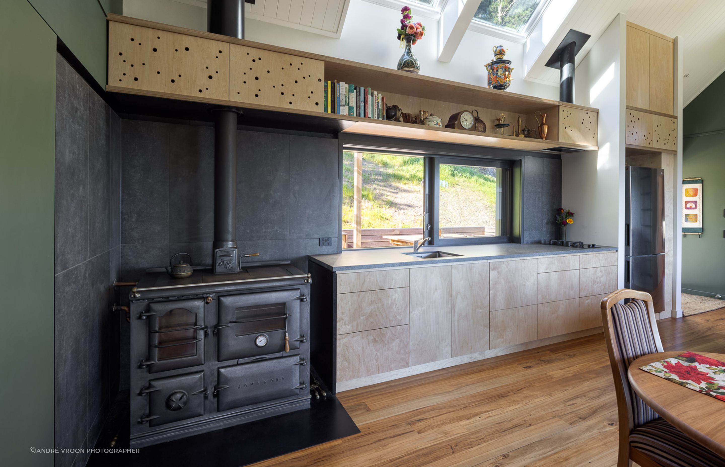 A modest footprint of 75sqm keeps the dwelling compact, with two loft areas extending the usable space. At the heart of the home is the kitchen.
