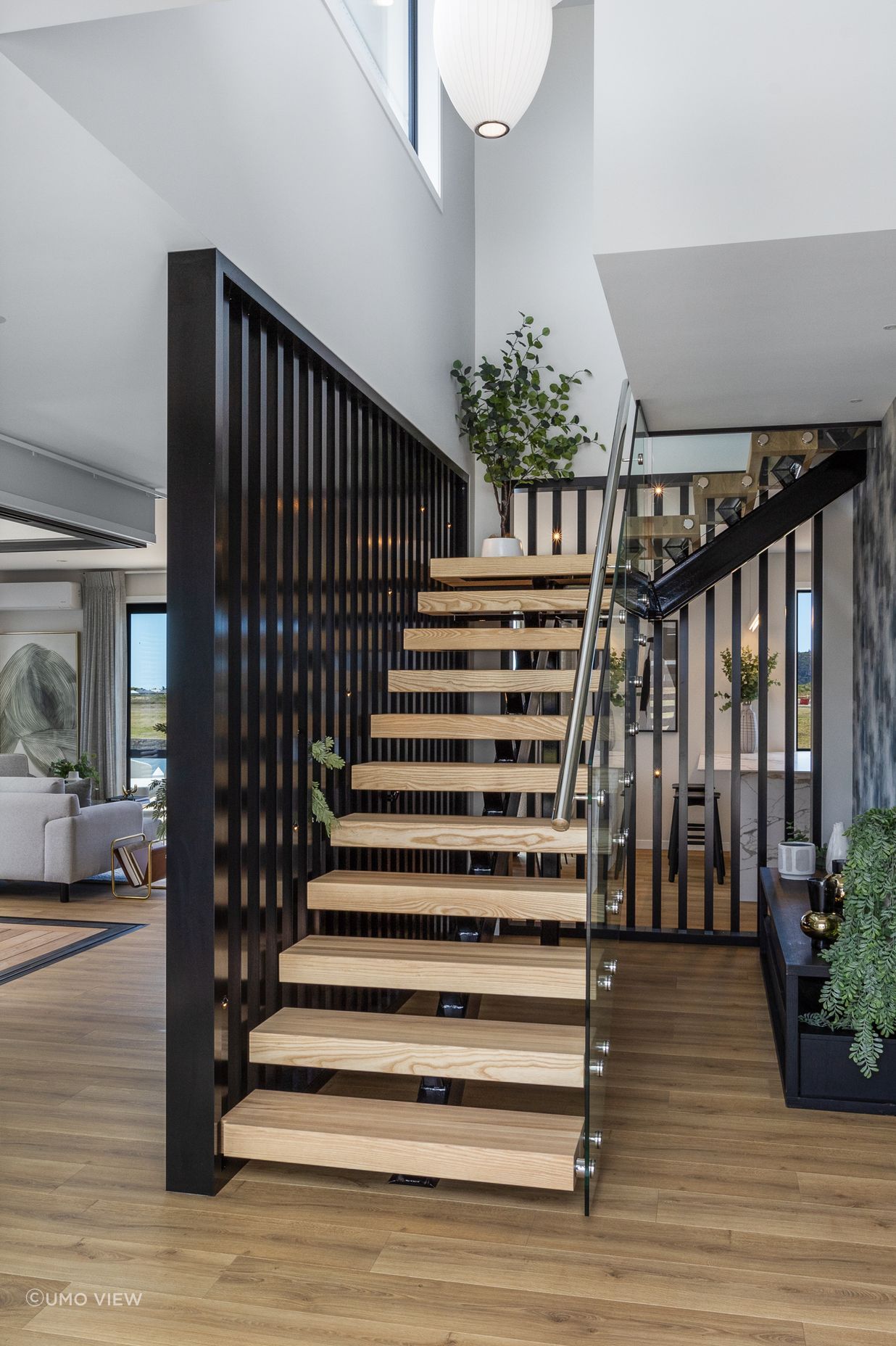 The stairwell leading to the second level creates a point of interest and sets the tone for the home’s sophisticated style.