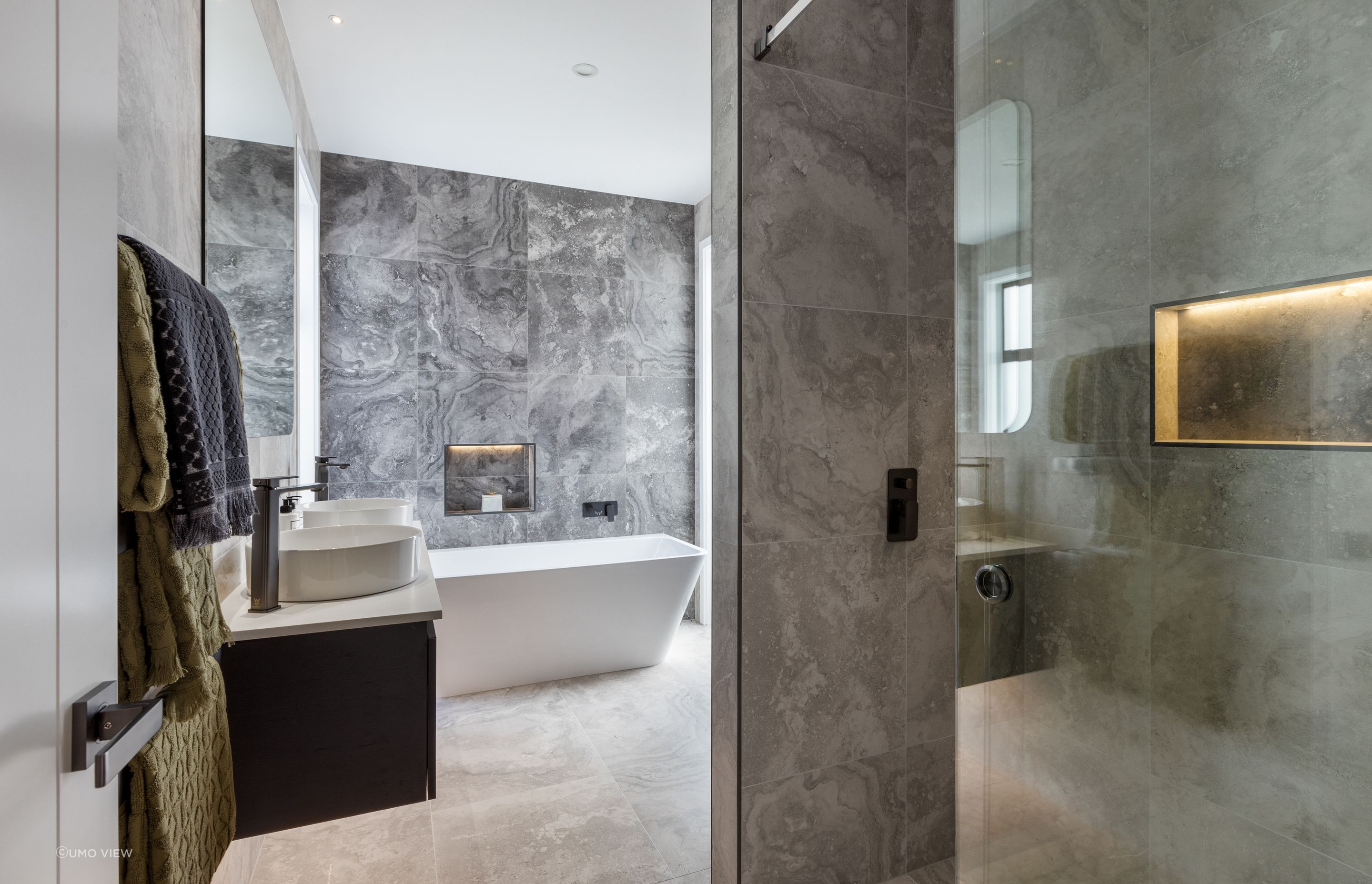 “A standout feature in both bathrooms is the innovative use of glass sliding doors for the showers. The doors not only add a modern touch but also enhance the sense of openness within the bathrooms.”