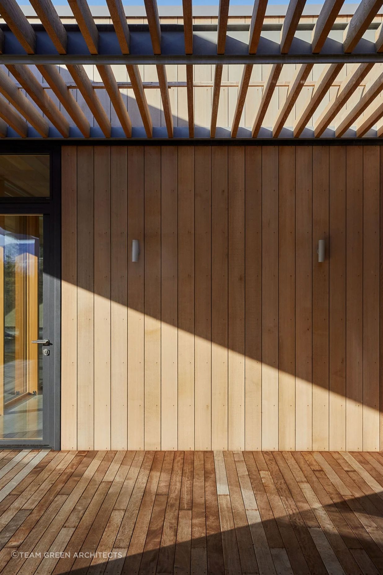 The corrugated iron cladding contrasts with the softness of timber.