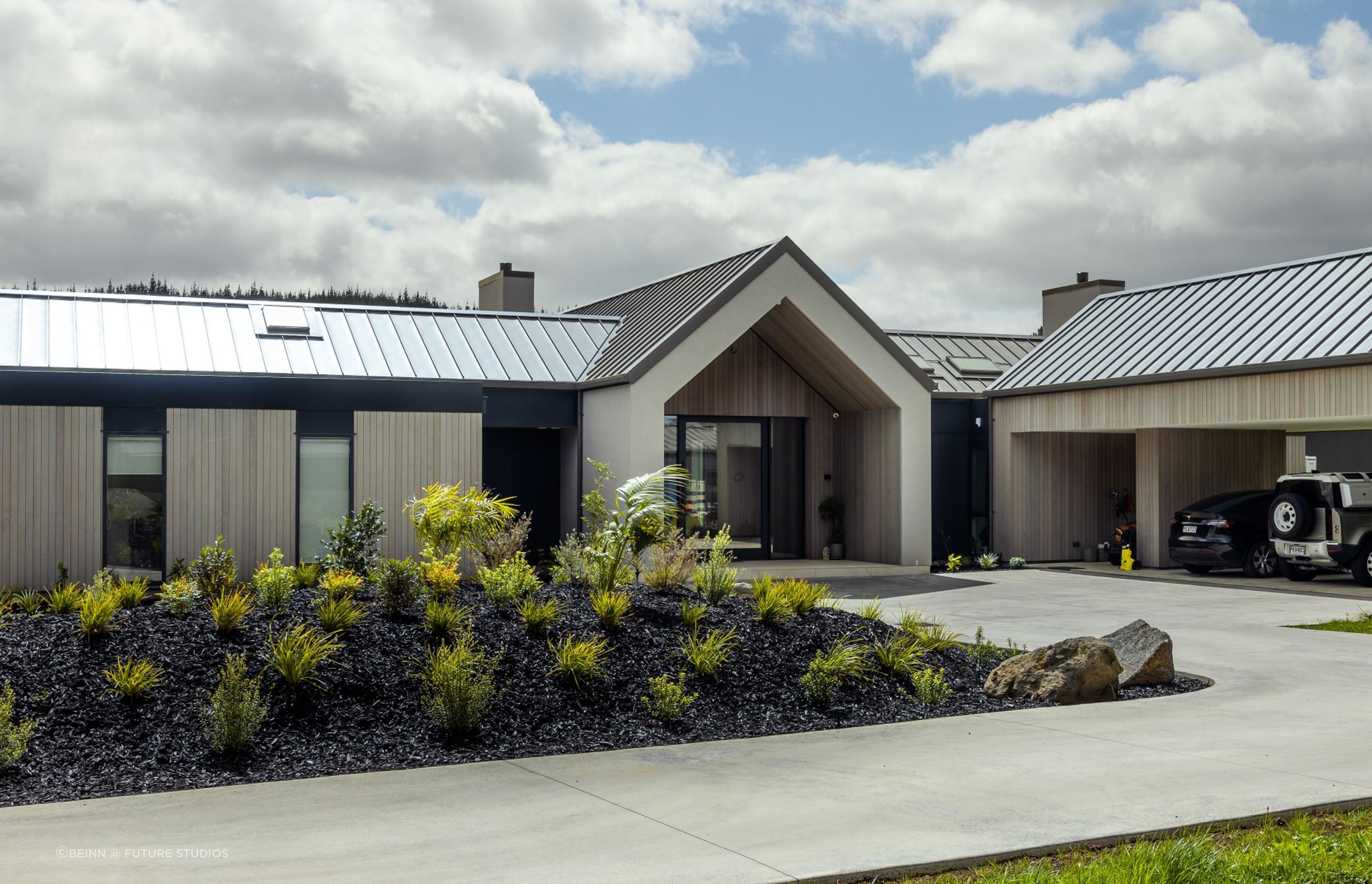 The entry to the homes is neatly recessed into a central gable form, creating a sheltered space.