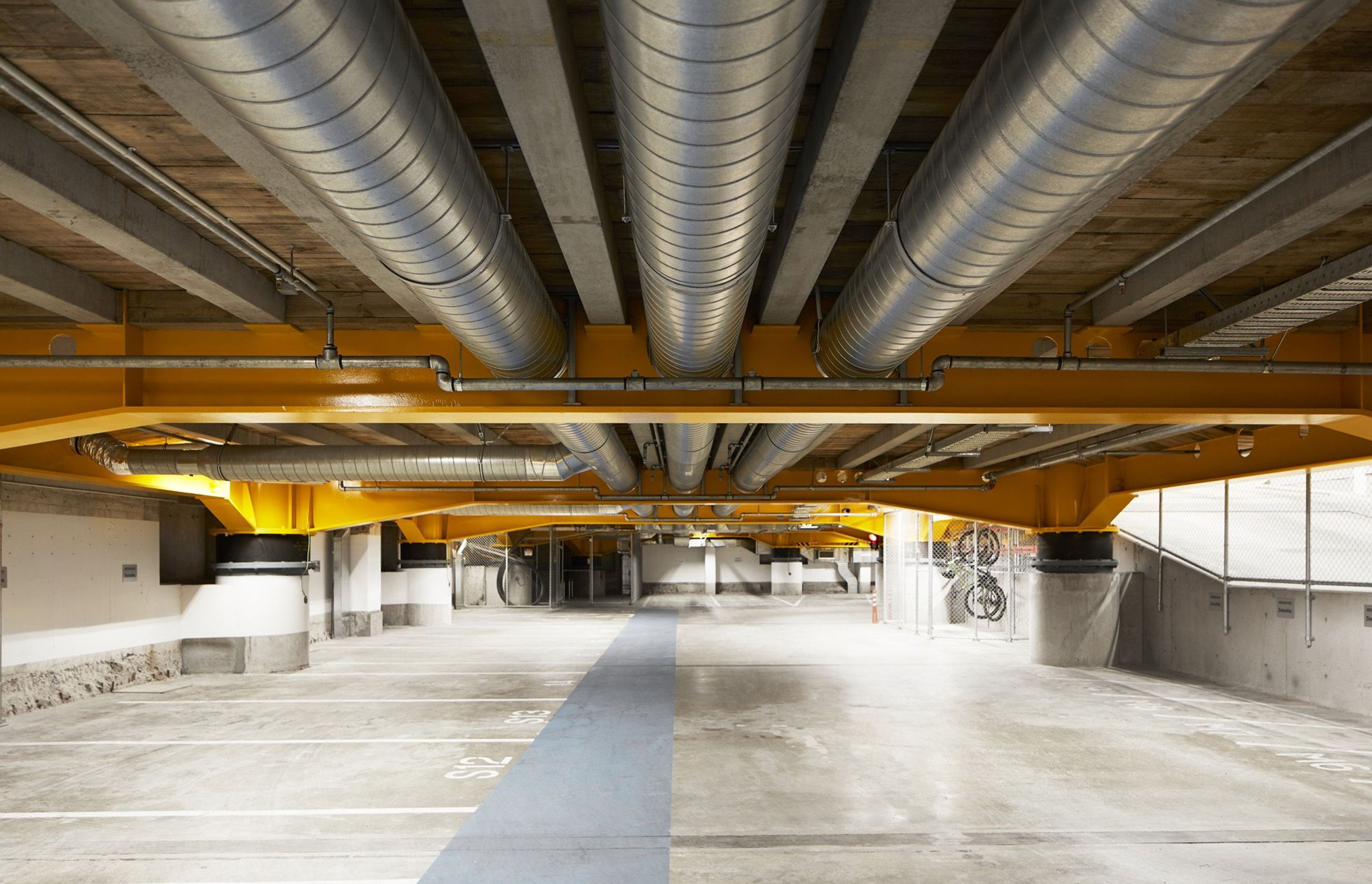 In the basement, the base isolators hold the weight of the building and allow the foundations to move sideways.