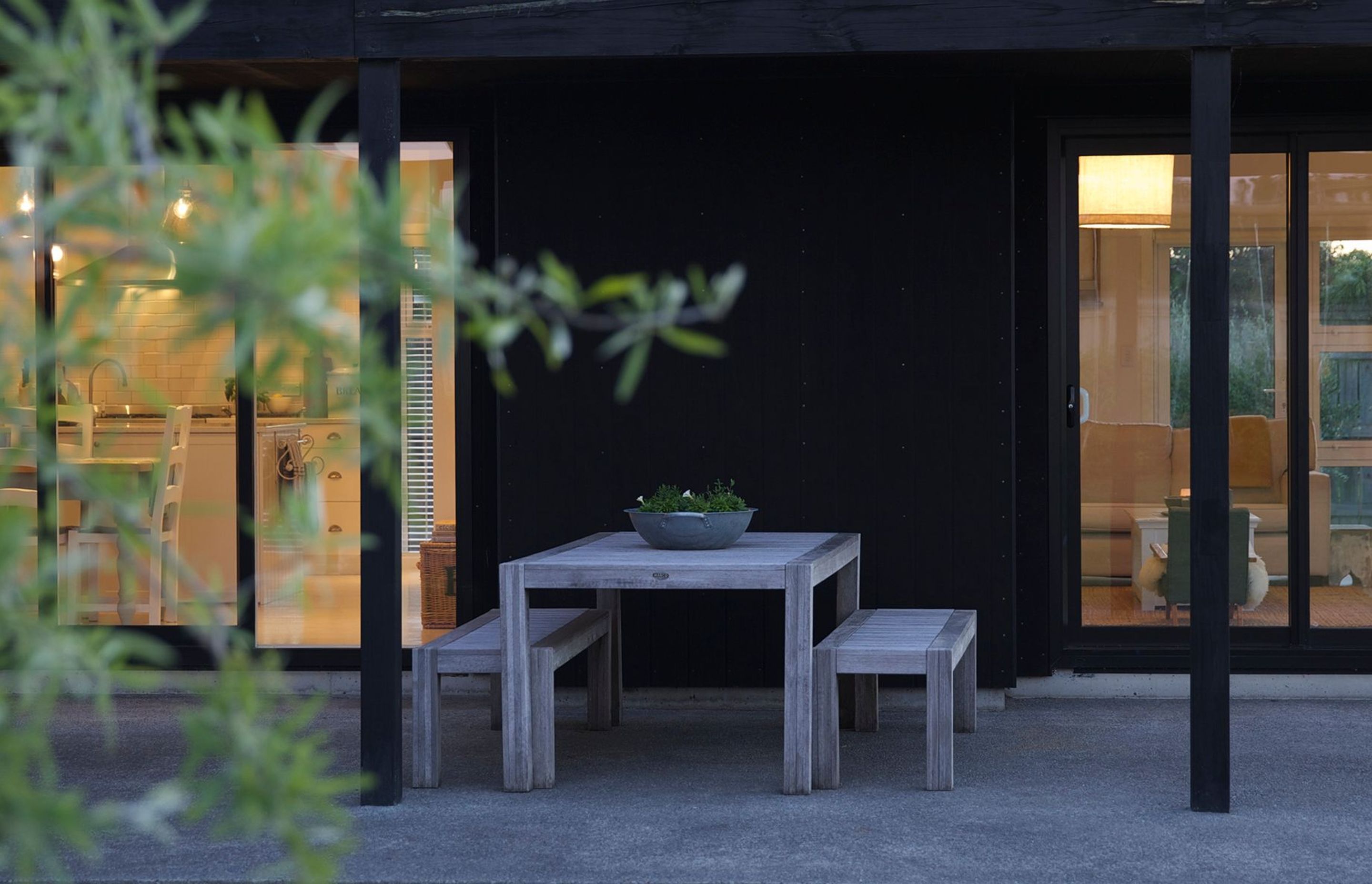 The sheltered outdoor dining area enjoys views of the rural Wairarapa landscape.