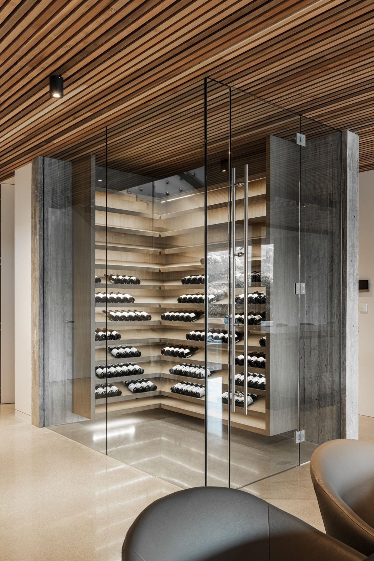 The wine cellar is a contemporary climatically controlled glass box.