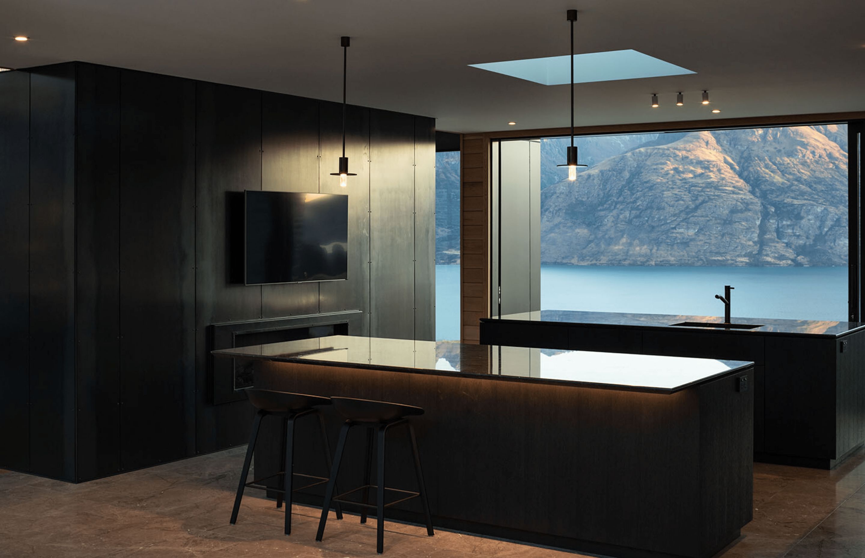 On either side of the kitchen are glass sliders that feature stunning views of the lake on one side, and the mountains on the other.