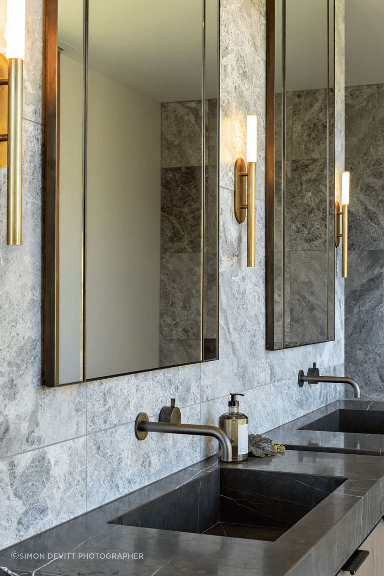 The master en suite has a luxurious feel, with custom vanity and steel accents.
