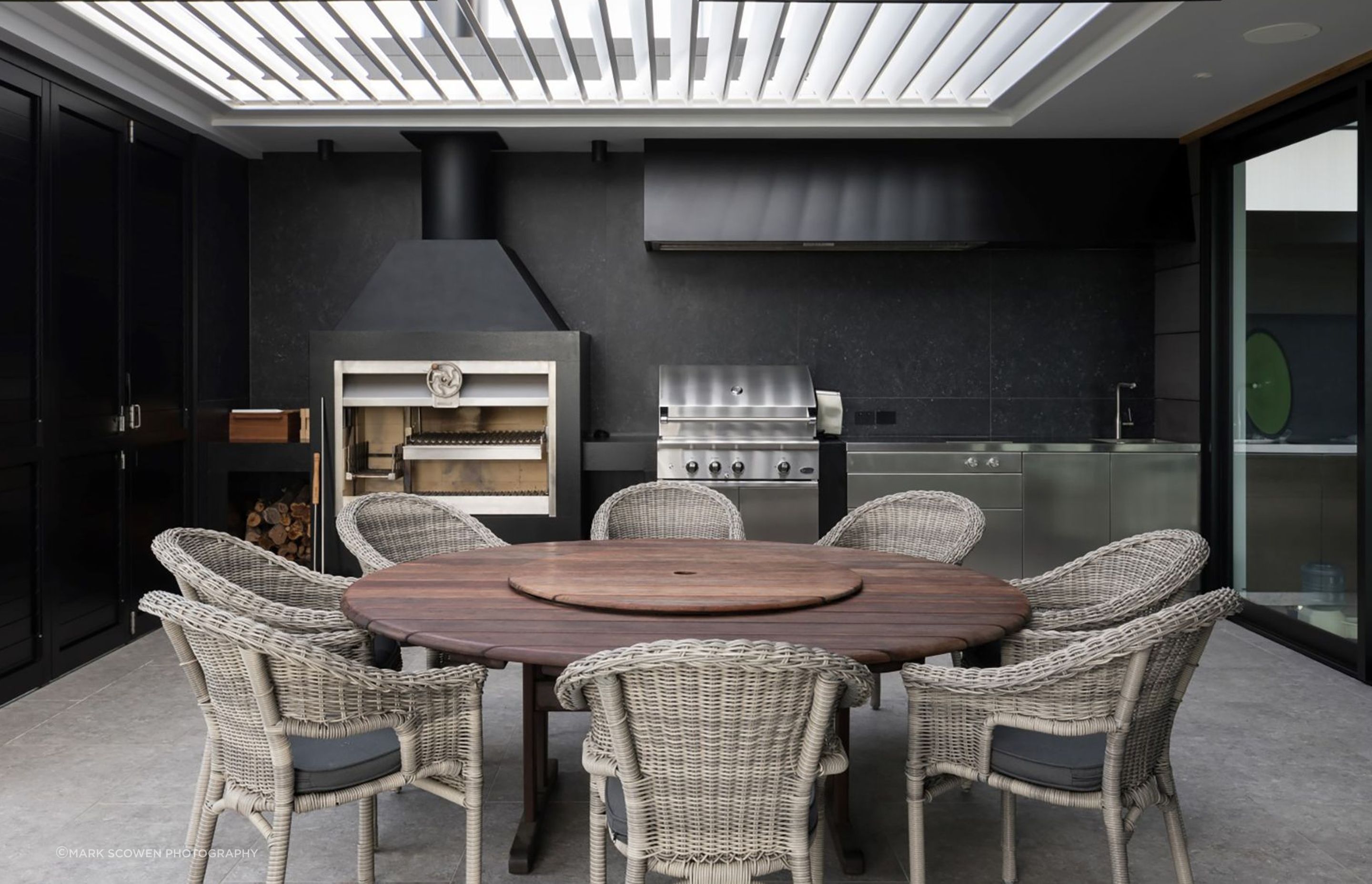 The outdoor room is directly linked to the kitchen and is the perfect place for entertaining, with adjustable overhead louvres providing light and shade.