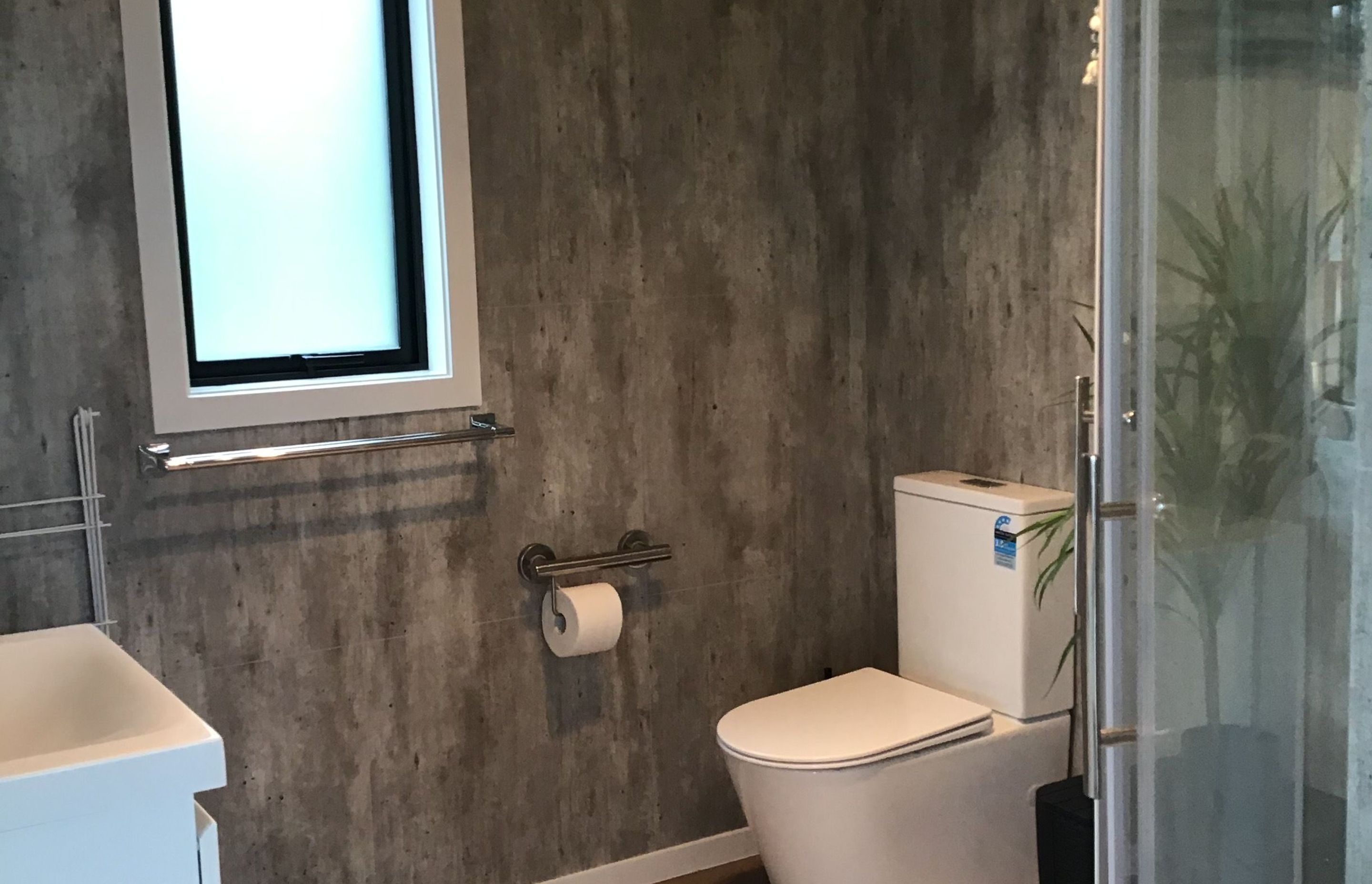Generous sized bathroom with grab rails to toilet and shower. Space for washing machine also