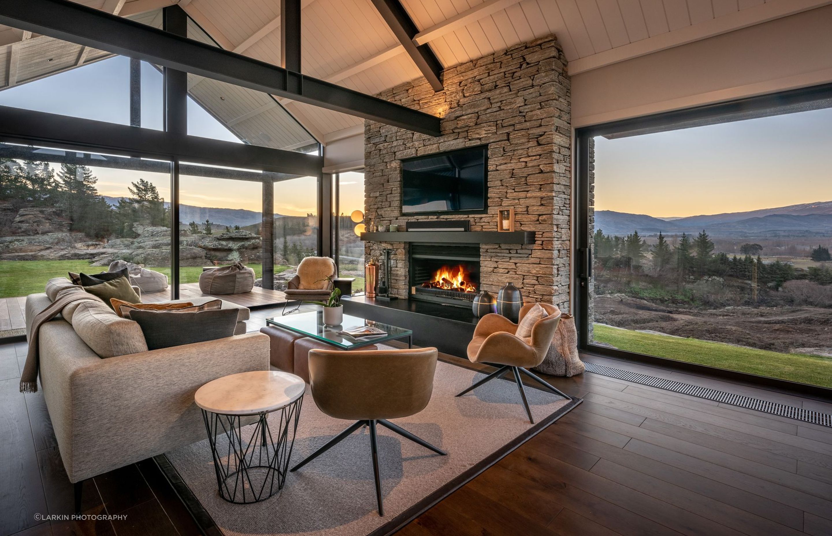 In front of the schist fireplace in the lounge is the perfect spot to relax in the evening and watch the sun set across the valley.