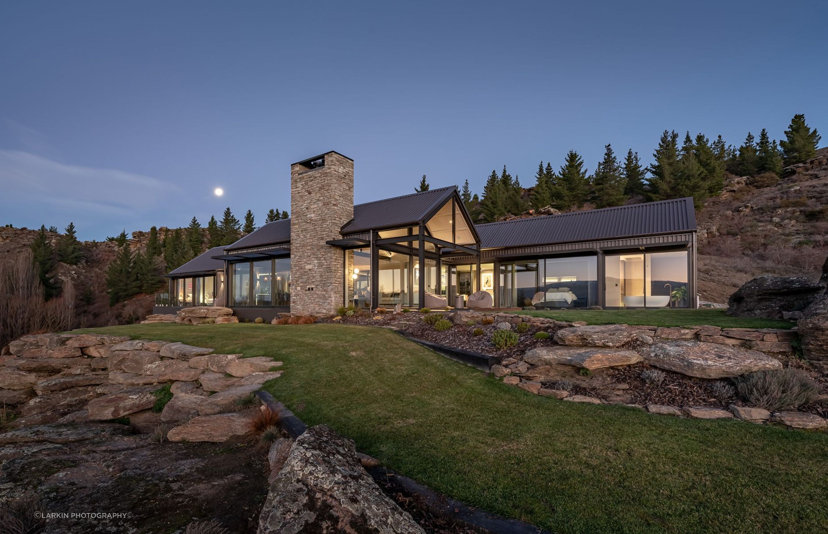 The home, built by CDL Building features three gable forms and schist chimneys.