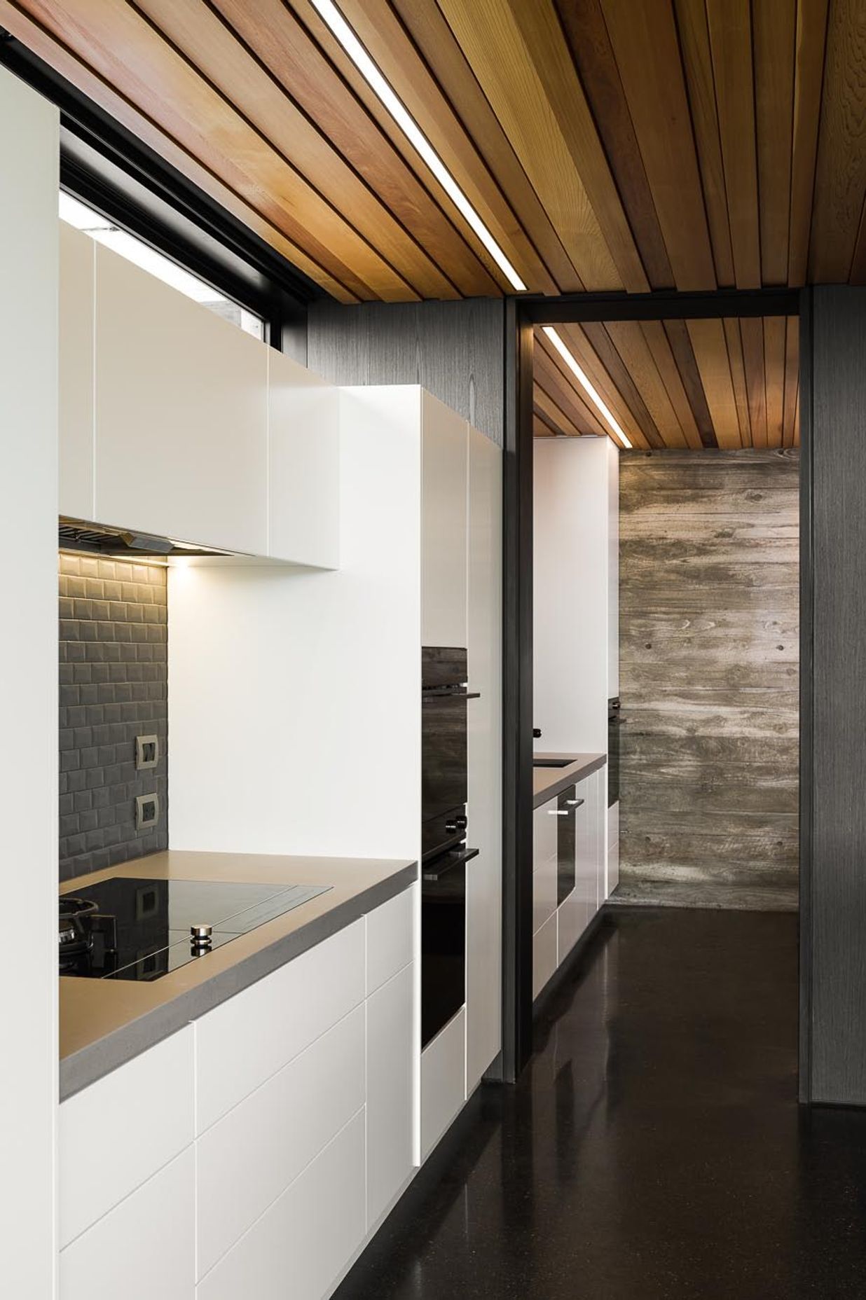 The simplicity of the kitchen mimics the overall simplicity of the building's design.