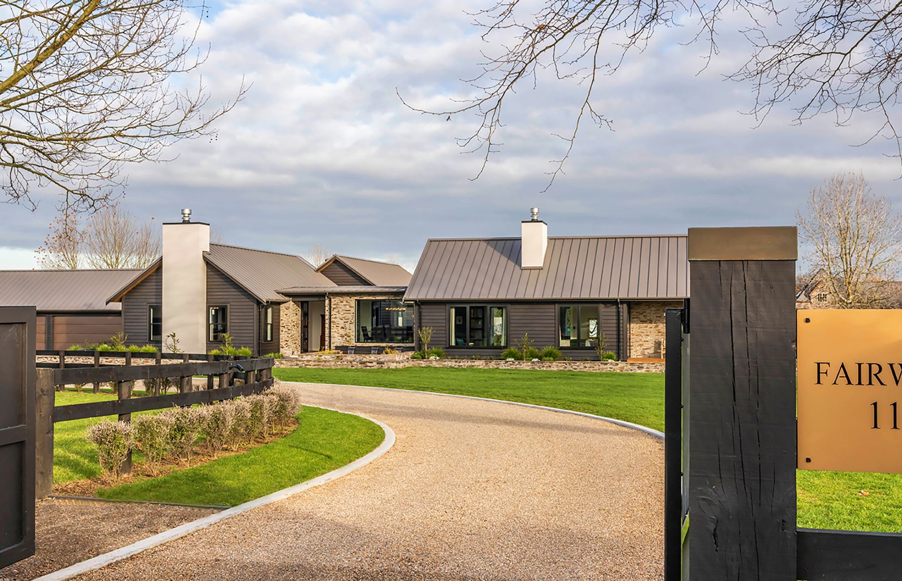 Set within idyllic Cambridge horse country, this rural home has a sophisticated lodge aesthetic with dark-stained cedar weatherboards and bagged stone to the exterior.